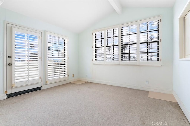 carpeted empty room with baseboards and vaulted ceiling with beams