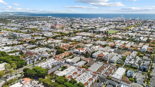 drone / aerial view featuring a view of city and a water view