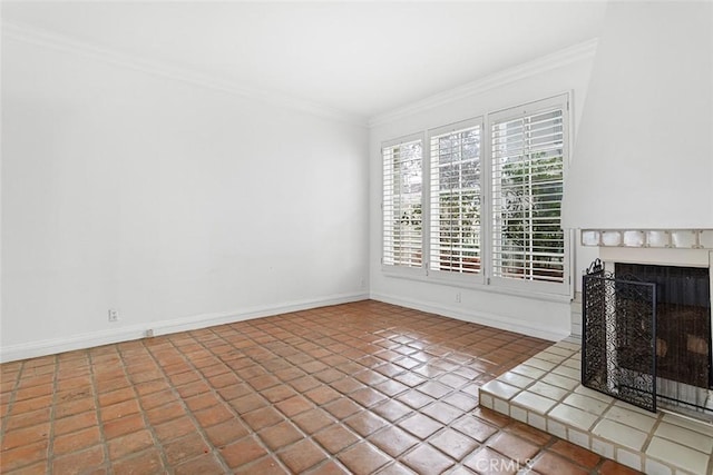 unfurnished living room with crown molding, a fireplace with raised hearth, tile patterned floors, and baseboards