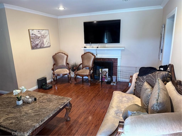 living room featuring a brick fireplace, recessed lighting, baseboards, wood finished floors, and ornamental molding