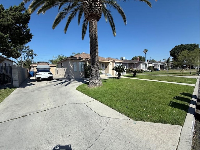 single story home with fence, driveway, and a front yard