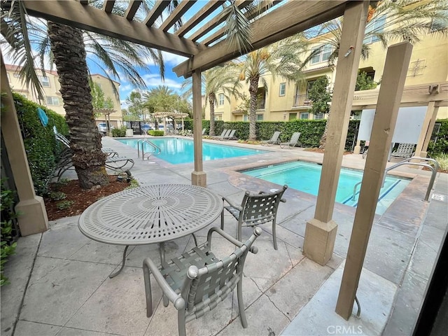 community pool with a pergola and a patio area