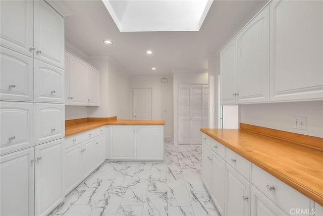 3442 Delta Ave, Rosemead, CA 91770 - kitchen featuring light marble finish floors, recessed lighting, white cabinetry, a peninsula, and ornamental molding