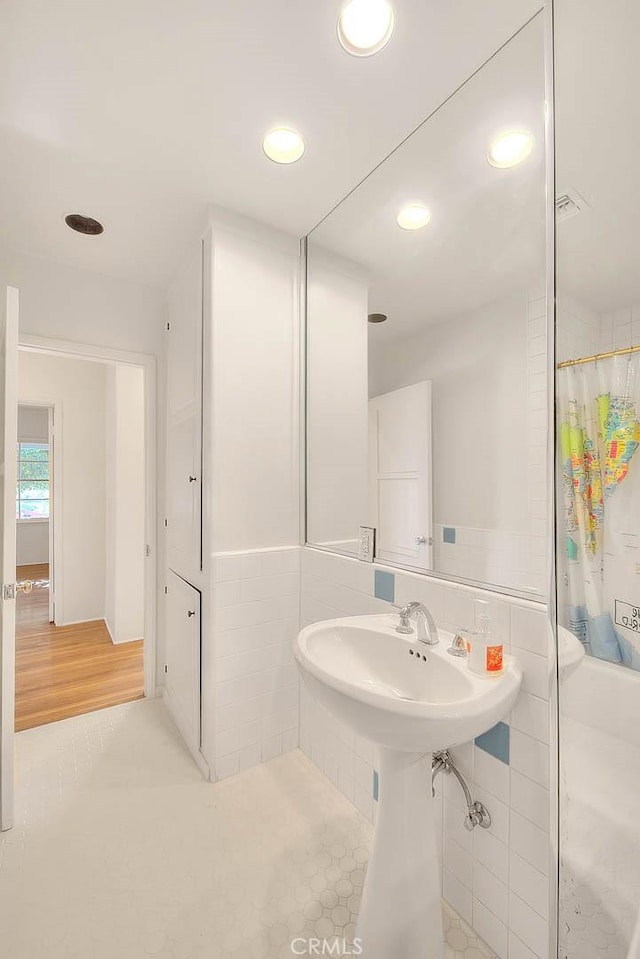 3442 Delta Ave, Rosemead, CA 91770 - bathroom featuring recessed lighting, curtained shower, and tile walls