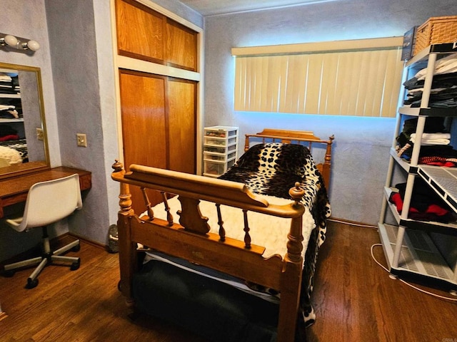bedroom featuring a closet and wood finished floors