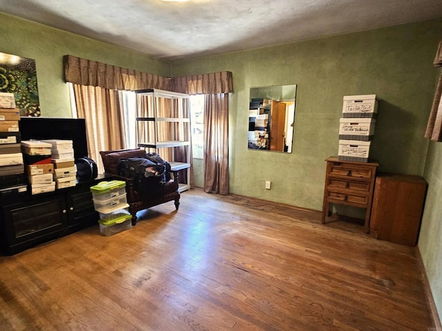 interior space with baseboards and wood finished floors