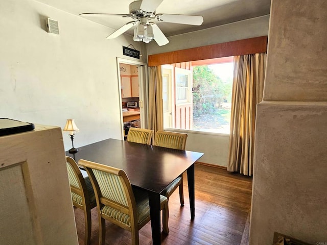 dining area with ceiling fan, visible vents, and wood finished floors