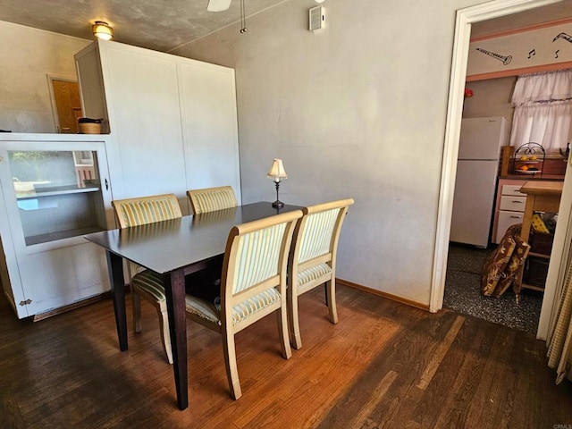 dining area featuring ceiling fan and wood finished floors