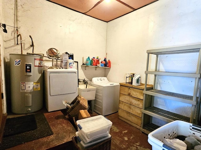 washroom featuring laundry area, a sink, washer and clothes dryer, and electric water heater