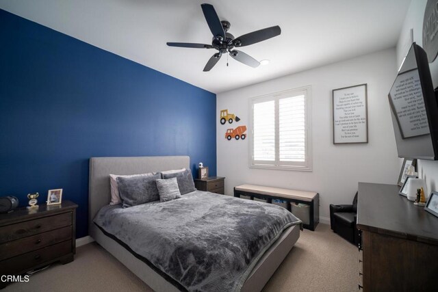 bedroom featuring baseboards, ceiling fan, and carpet