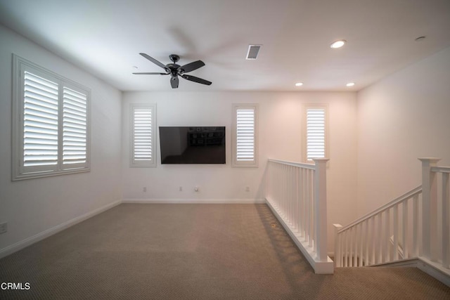 unfurnished living room with visible vents, carpet, and a healthy amount of sunlight