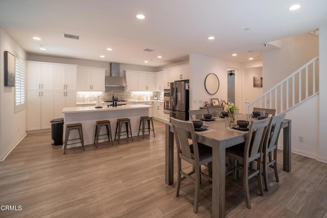 dining space featuring recessed lighting, light wood-style flooring, and visible vents