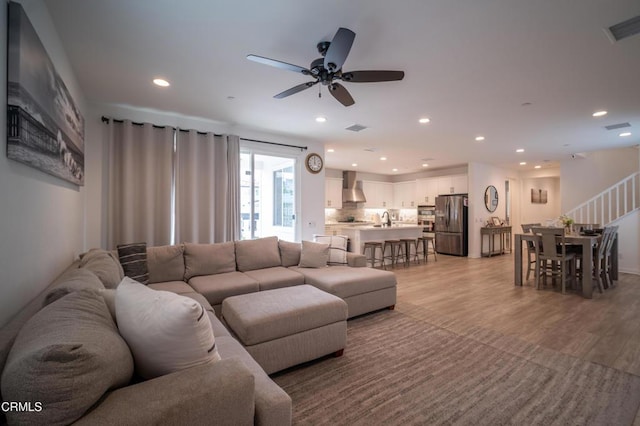living room featuring visible vents, recessed lighting, light wood finished floors, and ceiling fan