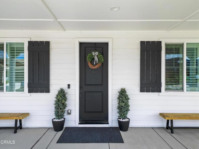 doorway to property featuring a porch
