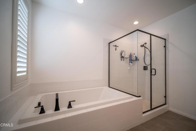 bathroom featuring recessed lighting, a wealth of natural light, a garden tub, and a stall shower