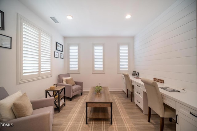 office area featuring recessed lighting, visible vents, built in desk, and light wood finished floors