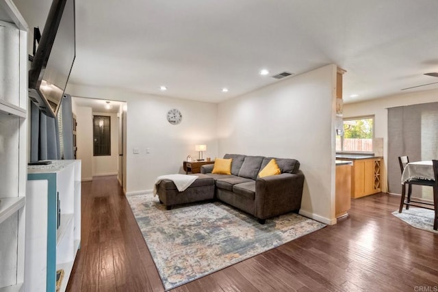 living area featuring visible vents, recessed lighting, and dark wood-style floors