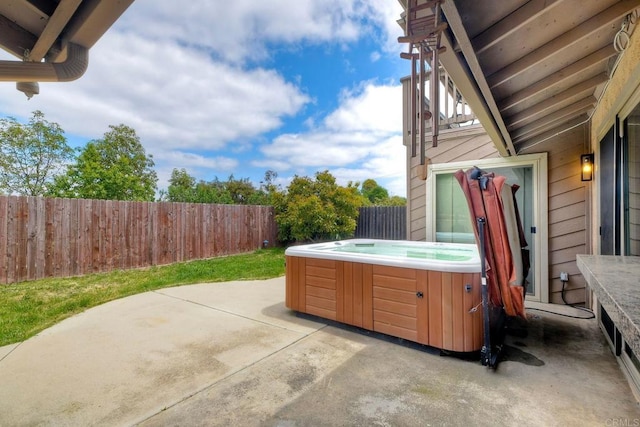 view of patio / terrace featuring a fenced backyard and a hot tub