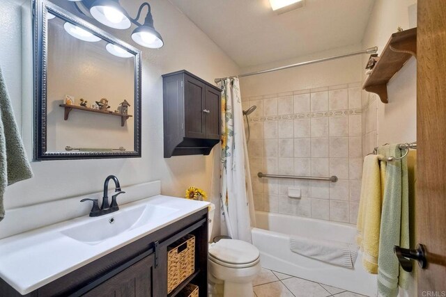 full bathroom with vanity, shower / tub combo with curtain, tile patterned floors, and toilet