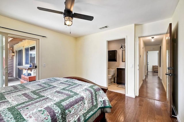 bedroom with visible vents, ensuite bathroom, baseboards, a ceiling fan, and dark wood finished floors