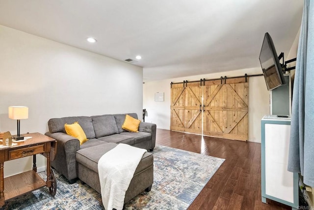 living area featuring recessed lighting, a barn door, and wood finished floors
