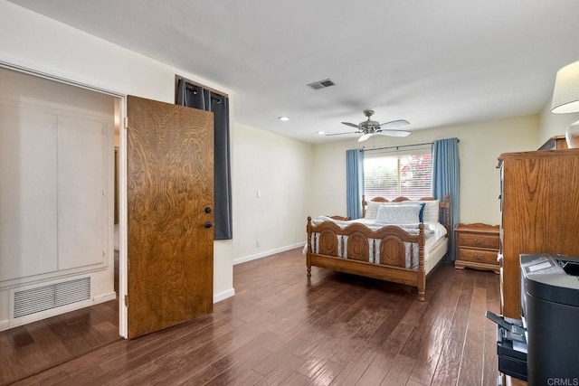 bedroom featuring visible vents, baseboards, ceiling fan, and hardwood / wood-style floors