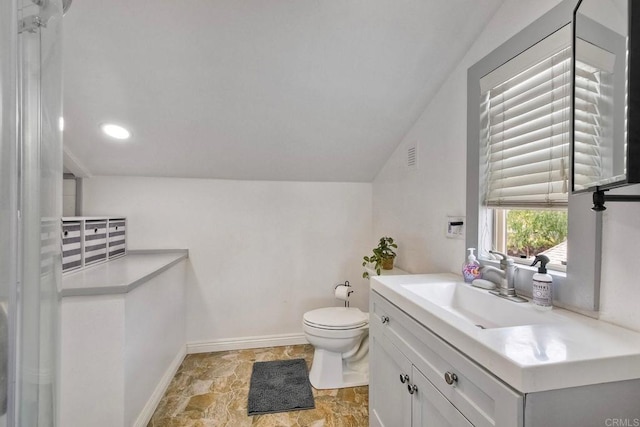bathroom with vanity, visible vents, lofted ceiling, toilet, and baseboards