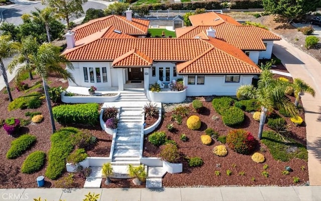 view of front of house with a tiled roof and stucco siding