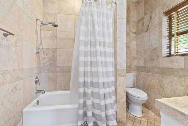 full bathroom featuring tile walls, tile patterned floors, shower / bath combo with shower curtain, and toilet