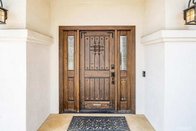 entrance to property featuring stucco siding