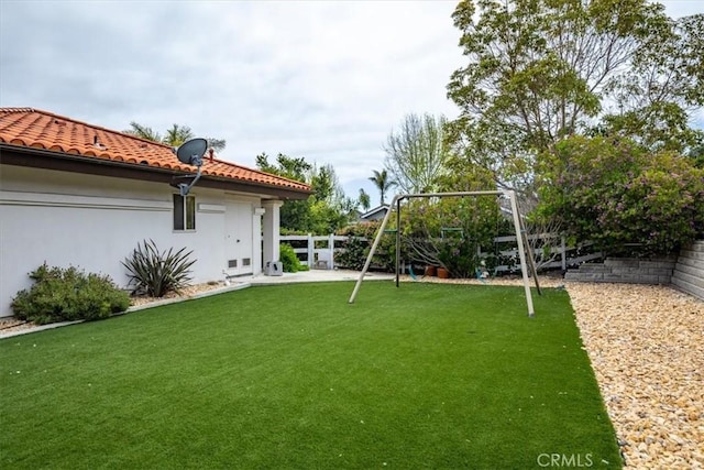 view of yard featuring a playground and a fenced backyard