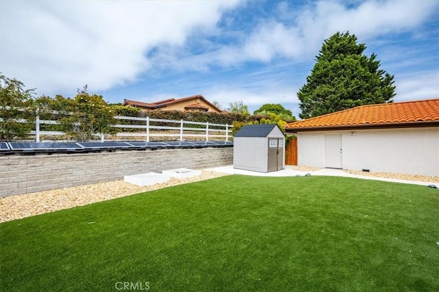 view of yard featuring a fenced backyard, an outbuilding, and a shed