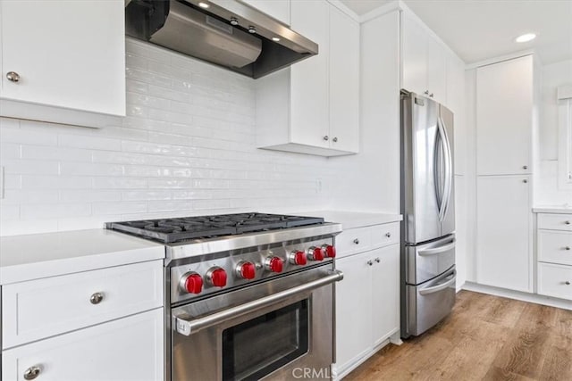 kitchen featuring light countertops, under cabinet range hood, white cabinets, and stainless steel appliances