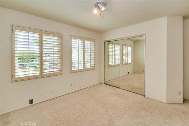 unfurnished bedroom featuring a closet and carpet flooring