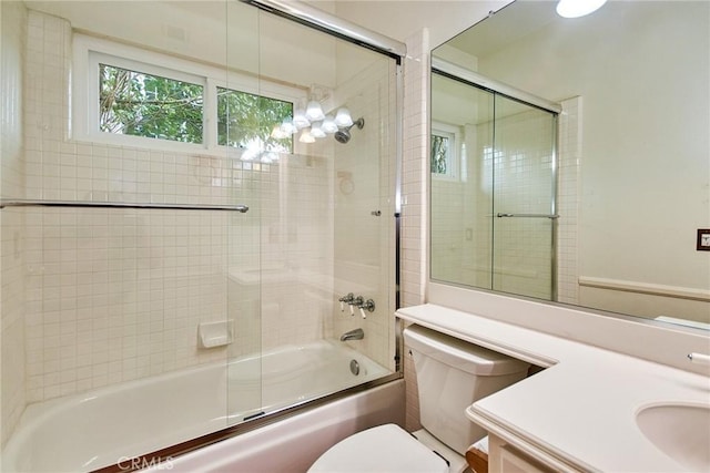 full bathroom with vanity, enclosed tub / shower combo, and toilet