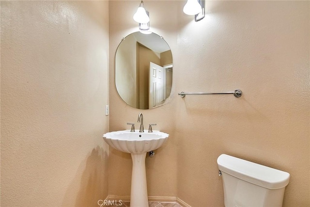 half bath featuring toilet