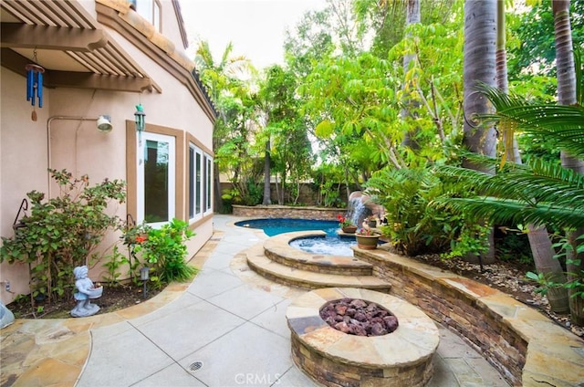 view of patio / terrace featuring a fenced backyard, a fenced in pool, and an outdoor fire pit