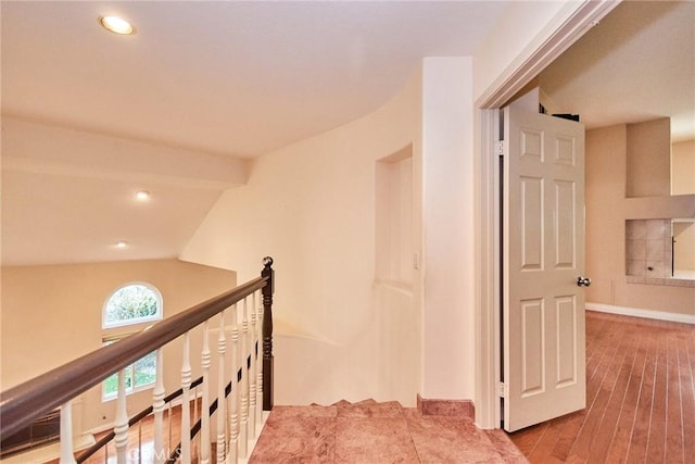 hall featuring recessed lighting, baseboards, an upstairs landing, and wood finished floors