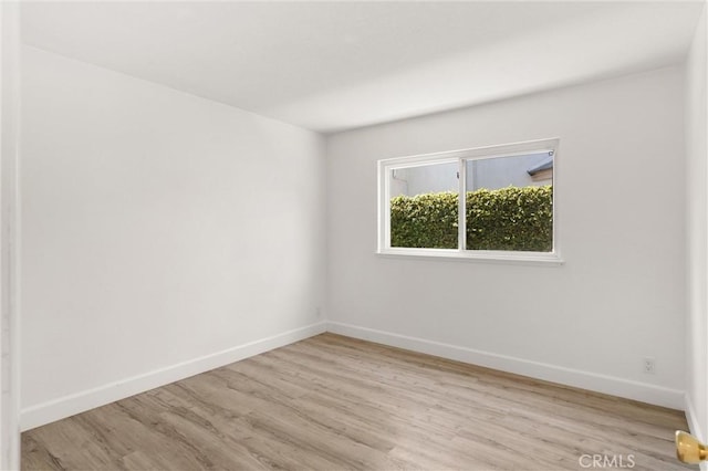 22122 Cape May Ln, Huntington Beach, CA 92646 - empty room featuring baseboards and wood finished floors