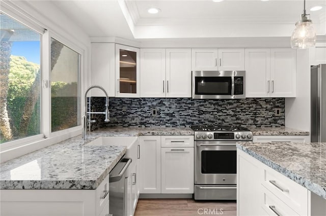 22122 Cape May Ln, Huntington Beach, CA 92646 - kitchen with a sink, appliances with stainless steel finishes, light wood-style flooring, and white cabinetry