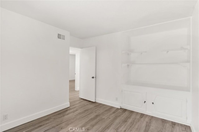 22122 Cape May Ln, Huntington Beach, CA 92646 - unfurnished room with baseboards, visible vents, and wood finished floors