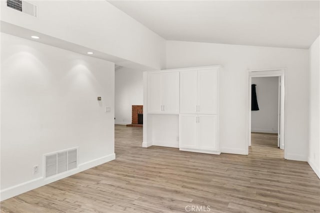 22122 Cape May Ln, Huntington Beach, CA 92646 - spare room featuring baseboards, vaulted ceiling, and visible vents