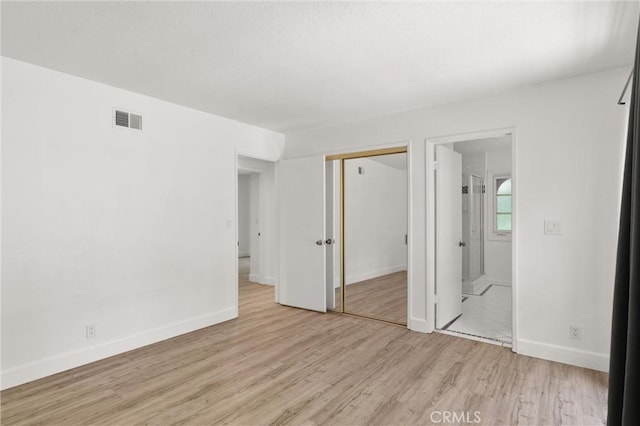 22122 Cape May Ln, Huntington Beach, CA 92646 - unfurnished bedroom with visible vents, a closet, baseboards, light wood finished floors, and ensuite bath