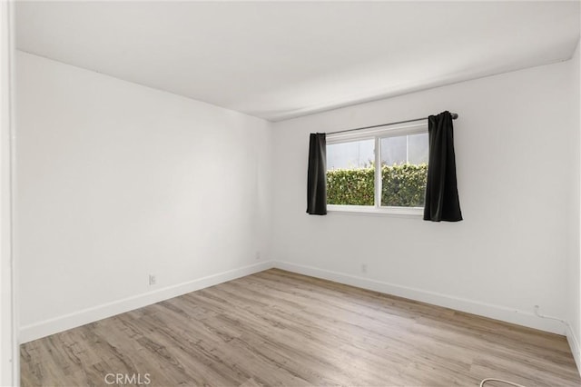 22122 Cape May Ln, Huntington Beach, CA 92646 - spare room featuring light wood-style floors and baseboards