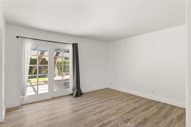 22122 Cape May Ln, Huntington Beach, CA 92646 - empty room with baseboards, a textured ceiling, and wood finished floors