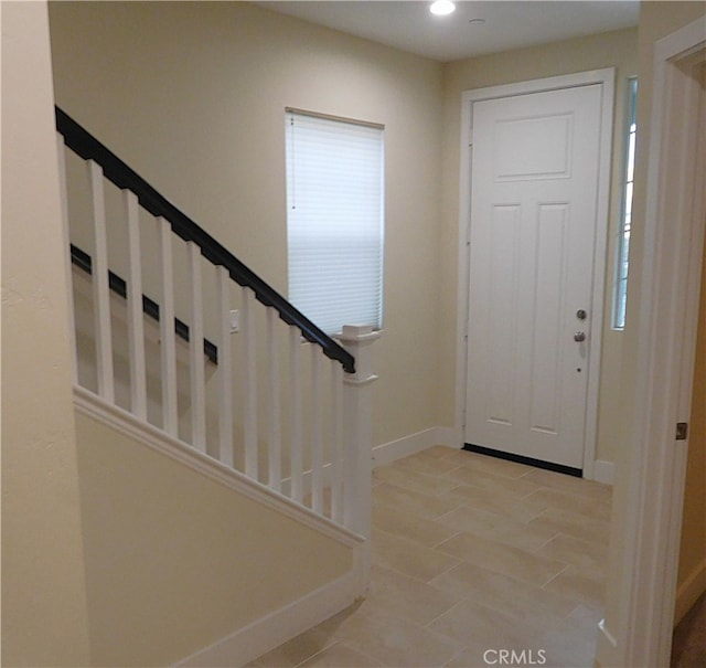 entryway featuring recessed lighting, baseboards, and stairs