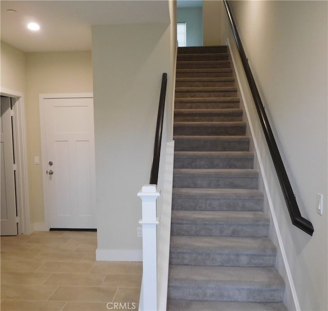stairs with baseboards and recessed lighting