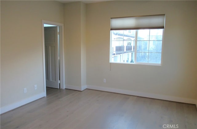 empty room featuring baseboards and wood finished floors