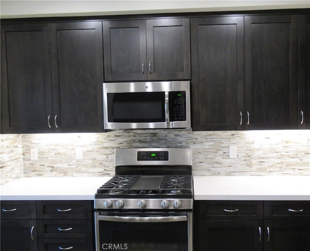 kitchen featuring light countertops, appliances with stainless steel finishes, and tasteful backsplash