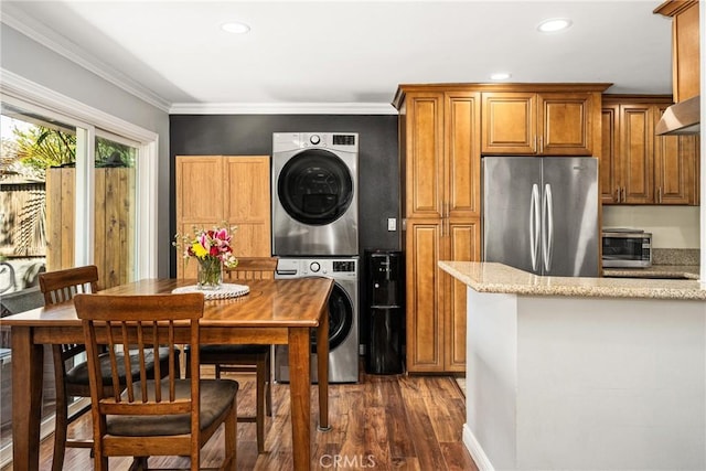 134 S Magnolia Ave Unit 21A, Anaheim, CA 92804 - kitchen featuring freestanding refrigerator, dark wood-style flooring, stacked washer / drying machine, and recessed lighting